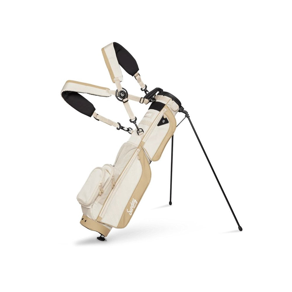 A beige golf bag with black straps and accents, featuring multiple pockets and a stand system, set against a white background.