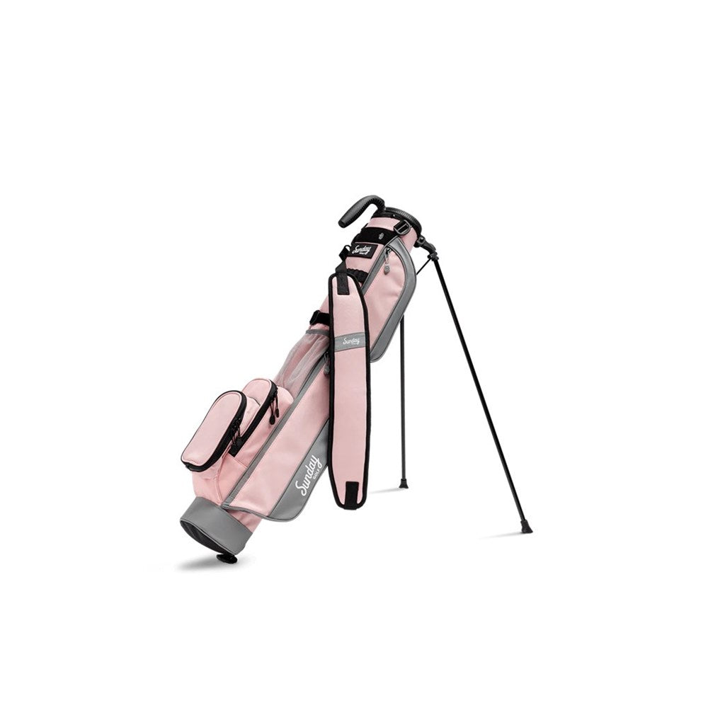 A pink and gray golf bag with a full-length shoulder strap, insulated drink pouch, and built-in stand, displayed on a white background.