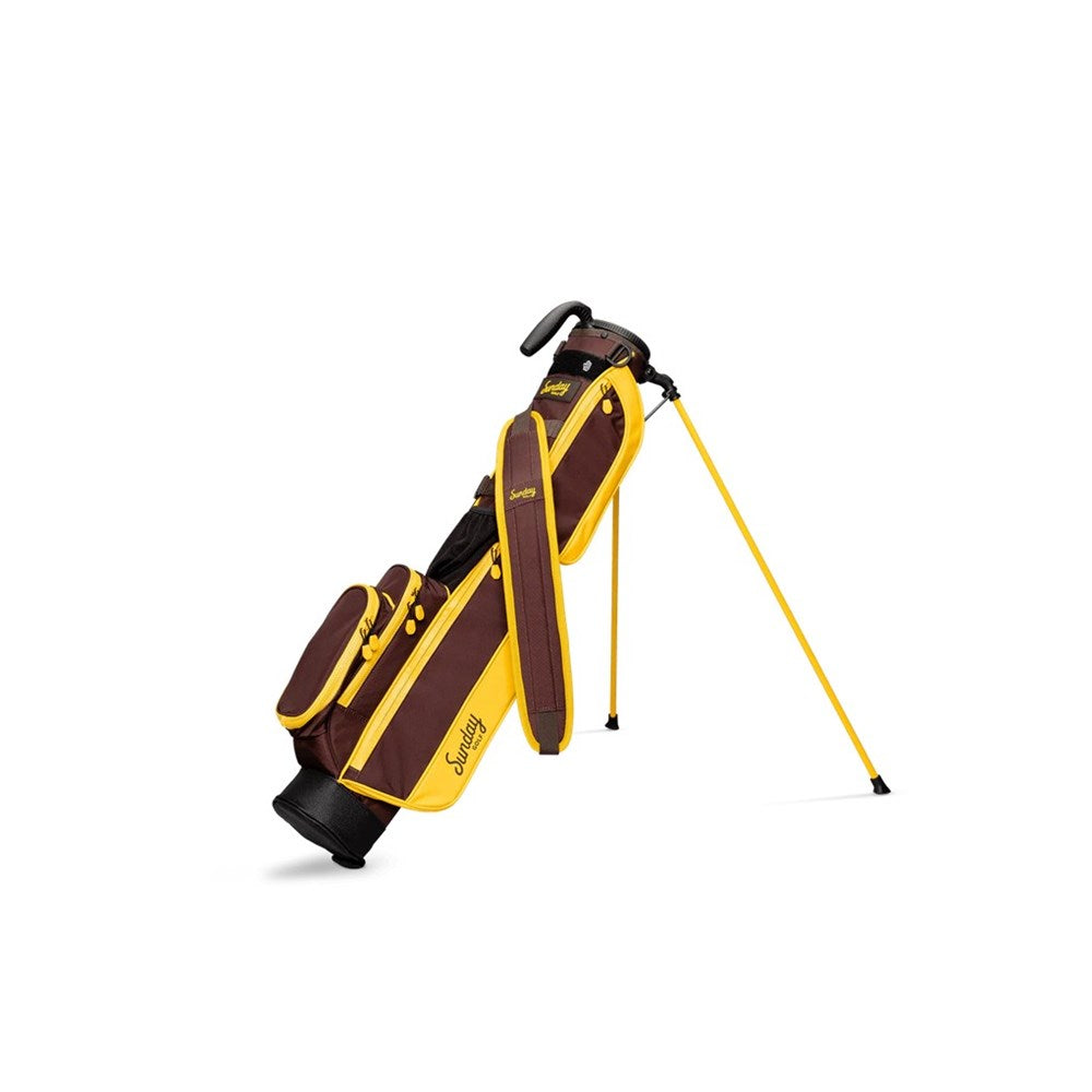 A yellow and maroon golf bag with a full-length shoulder strap, insulated drink pouch, and club divider, standing on built-in stand.