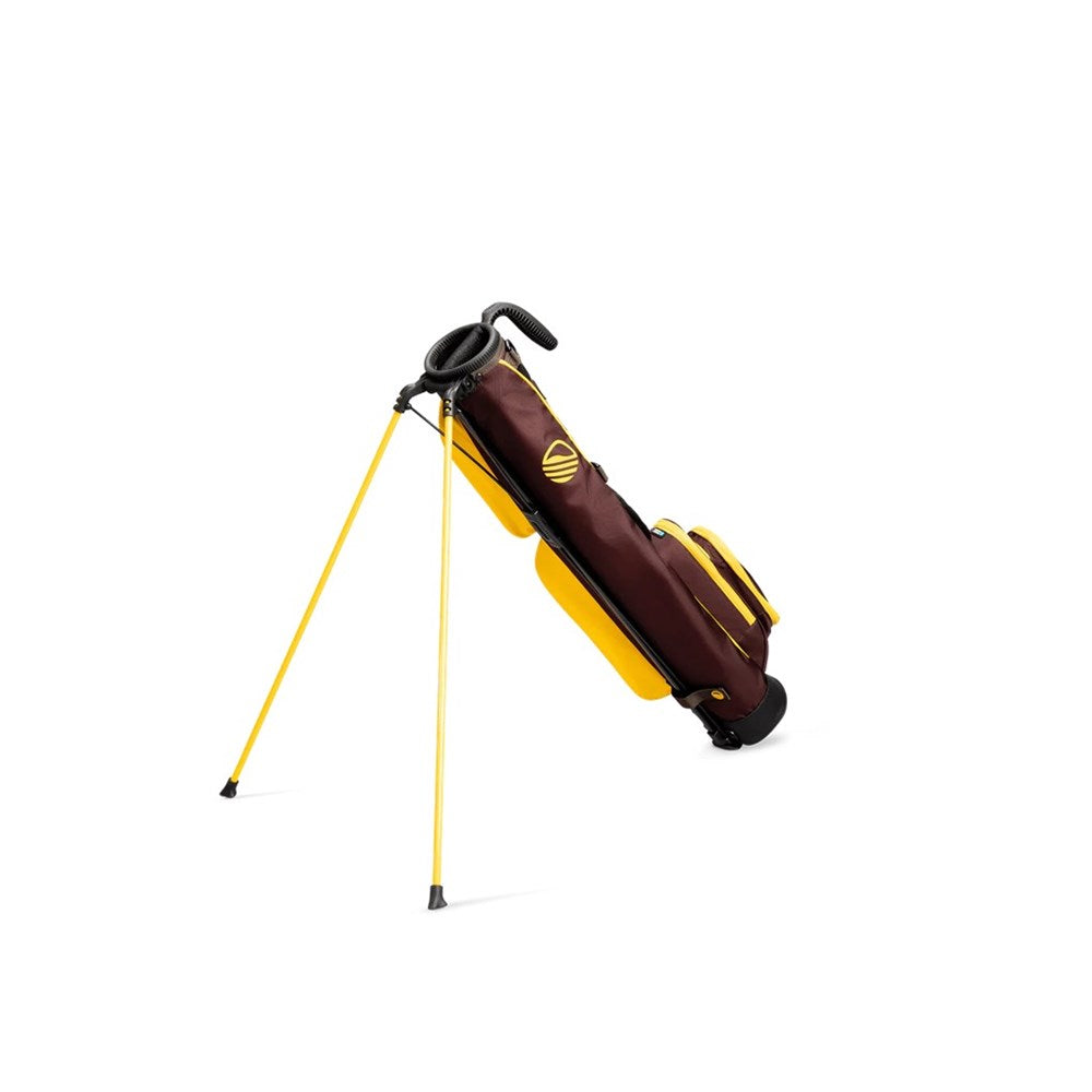 A yellow and maroon golf bag with a full-length shoulder strap, insulated drink pouch, and club divider, standing on built-in stand.