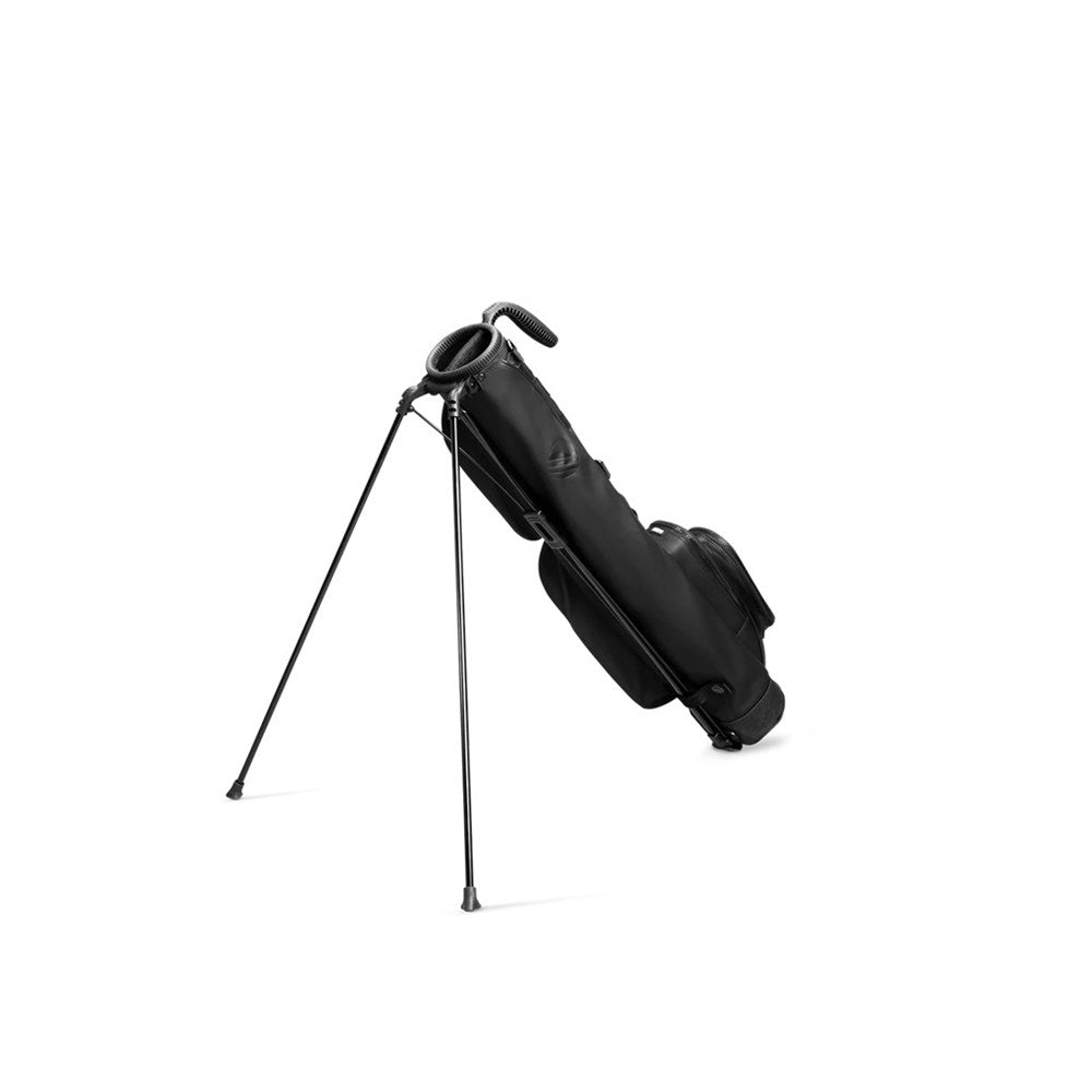A black golf bag with a stand system, featuring multiple pockets and a shoulder strap.