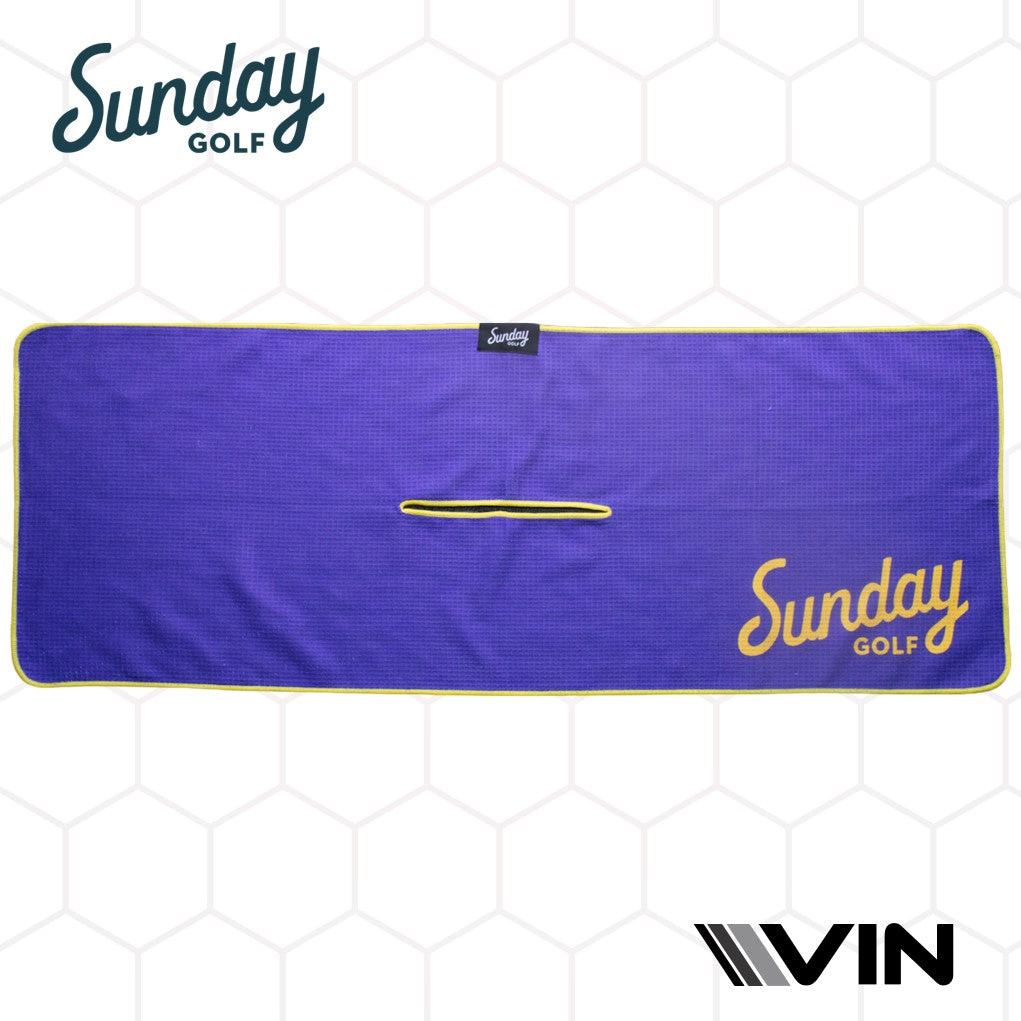 A golf towel with a checkered pattern in purple and yellow colors, featuring the 'Sunday Golf' logo.