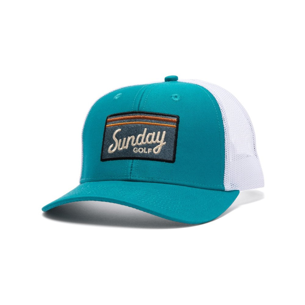 A blue and white trucker golf hat with a curved bill, featuring an embroidered front logo patch, mesh panels, and a snapback closure.