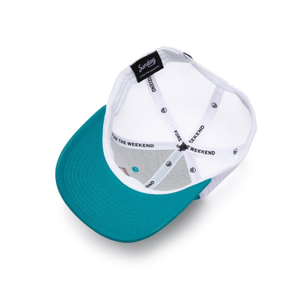 A blue and white trucker golf hat with a curved bill, featuring an embroidered front logo patch, mesh panels, and a snapback closure.