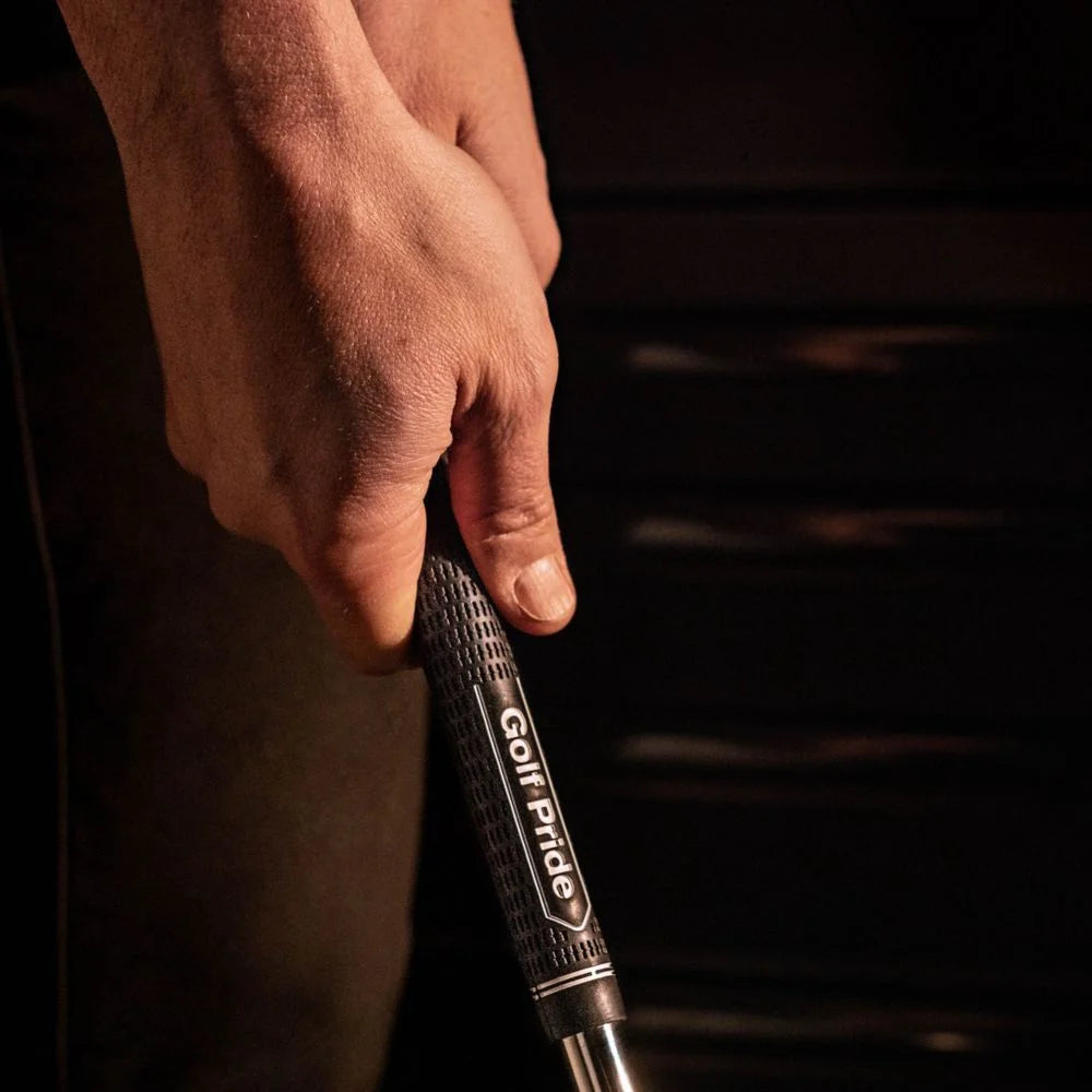 A black Golf Pride Tour Velvet golf club grip with a plus sign texture pattern.
